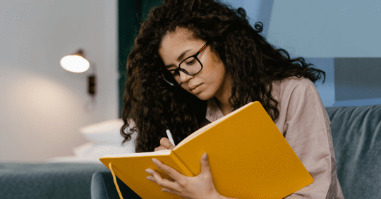 woman writing in journal